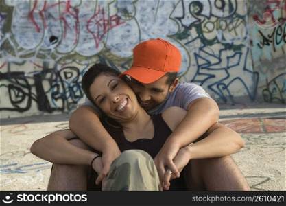 Young man embracing a young woman from behind