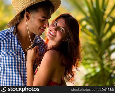 Young man embracing smiling woman, portrait