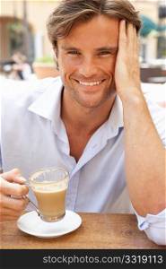 Young Man Enjoying Cup Of Coffee In CafZ