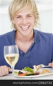 Young Man Enjoying meal,mealtime With A Glass Of Wine
