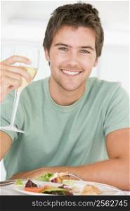 Young Man Enjoying meal,mealtime With A Glass Of Wine