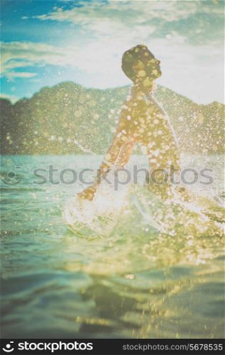 Young man enjoying the sea at sunset