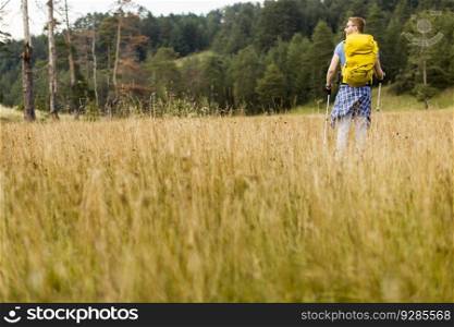Young man enjoys hiking on a sunny day
