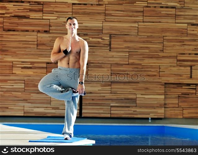 young man exercise and practice yoga fitness in lotus position indoor