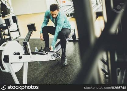Young man exercise on an exercise machine at the gym