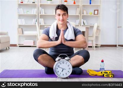 Young man exercising at home in sports and healthy lifestyle concept. Young man exercising at home in sports and healthy lifestyle con