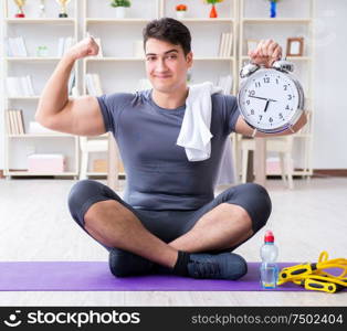 Young man exercising at home in sports and healthy lifestyle concept. Young man exercising at home in sports and healthy lifestyle con