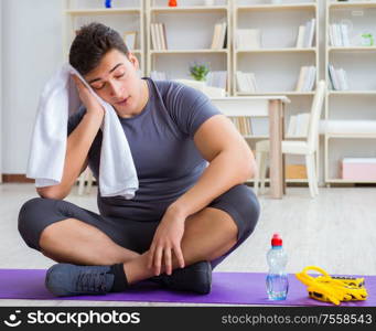 Young man exercising at home in sports and healthy lifestyle concept. Young man exercising at home in sports and healthy lifestyle con