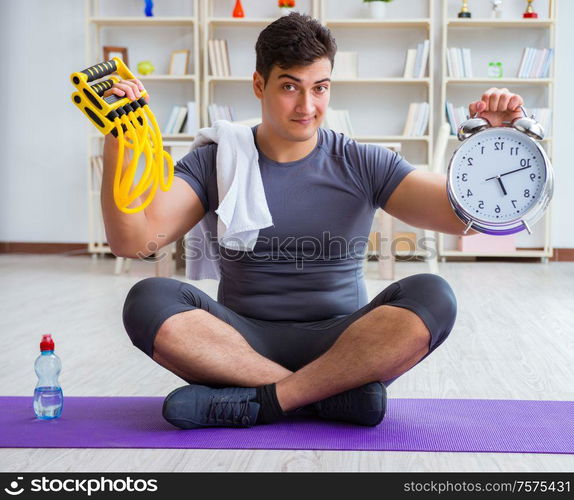 Young man exercising at home in sports and healthy lifestyle concept. Young man exercising at home in sports and healthy lifestyle con