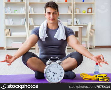 Young man exercising at home in sports and healthy lifestyle concept. Young man exercising at home in sports and healthy lifestyle con