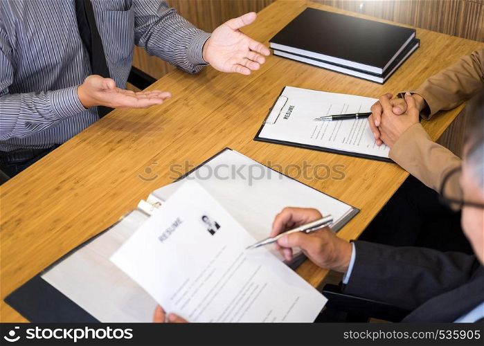 young man explaining about his profile to business managers sitting in job Interview. listen to candidate answers Hiring employee, nervously clutched scolded by boss
