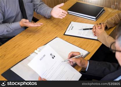 young man explaining about his profile to business managers sitting in job Interview. listen to candidate answers Hiring employee, nervously clutched scolded by boss