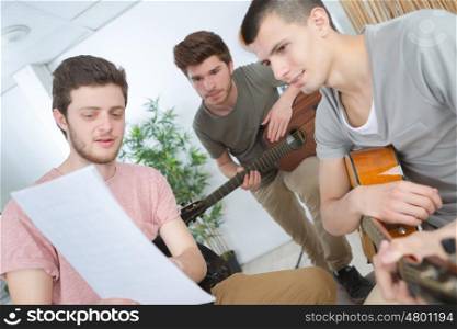 young man explains to the guitar players his party