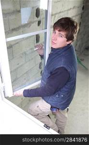 Young man fitting windows