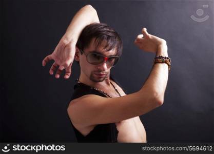 young man flamenco dancer wearing sunglasses on a black background