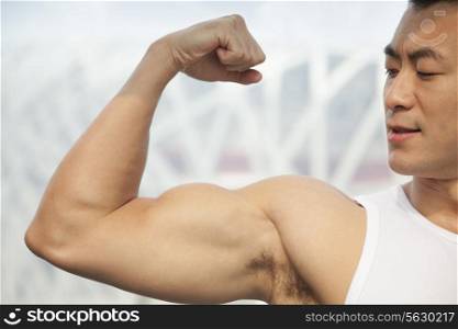 Young man flexing his bicep