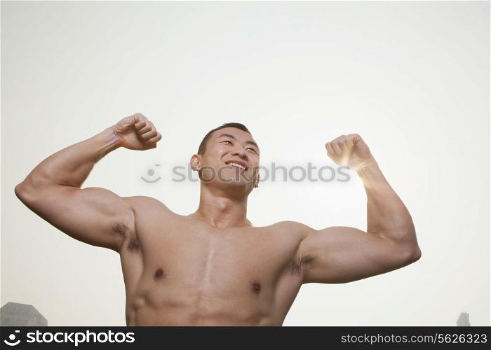 Young Man Flexing Muscles