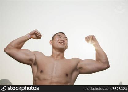 Young Man Flexing Muscles