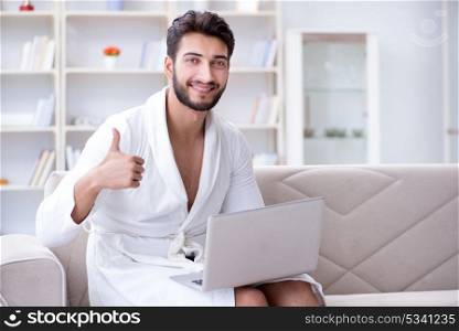 Young man freelancer working from home on a laptop
