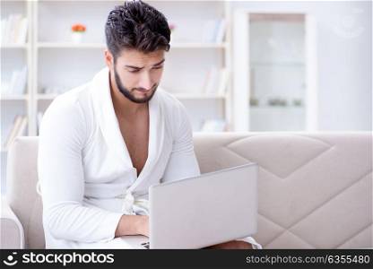 Young man freelancer working from home on a laptop