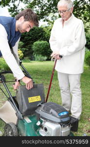 young man gardening with older woman