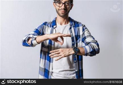 Young man gesturing in sign language, People who speak in sign language. Manual gestures of people with hearing problems, Person speaking in sign language isolated