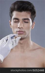 Young man getting botox injection