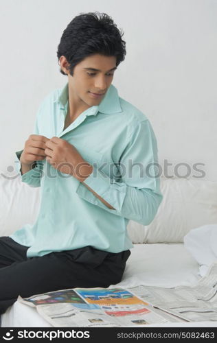 Young man getting dressed