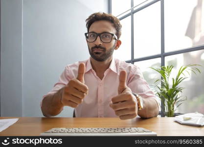 Young man giving a thumbs up while talking on video call