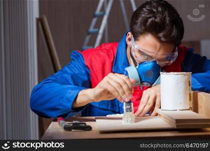 Young man gluing wood pieces together in DIY concept