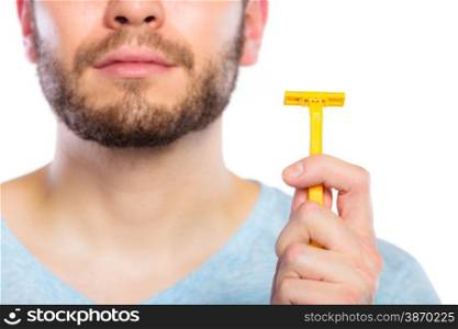 Young man guy with beard showing disposable yellow razor blade, studio shot on white background. Cropped image