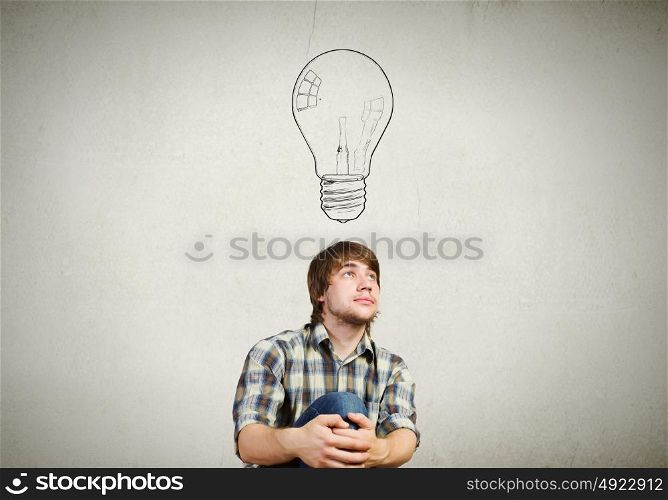 Young man has an idea. Young thoughtful guy and ideas coming out of his head