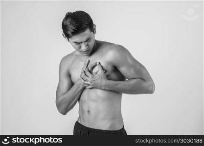 Young man has heart attack isolated on white background.