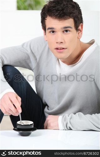 Young man having a cup of coffee
