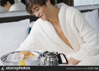 Young man having breakfast