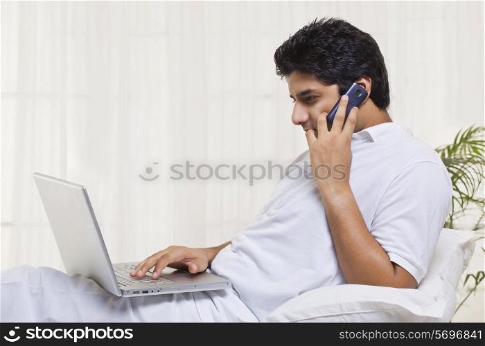 Young man having conversation while using laptop