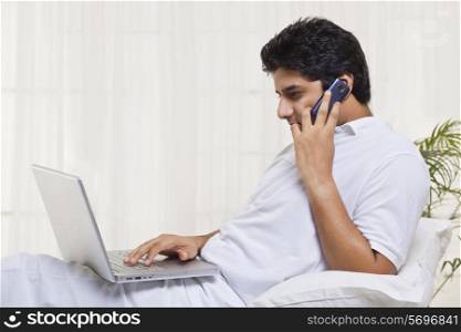 Young man having conversation while using laptop