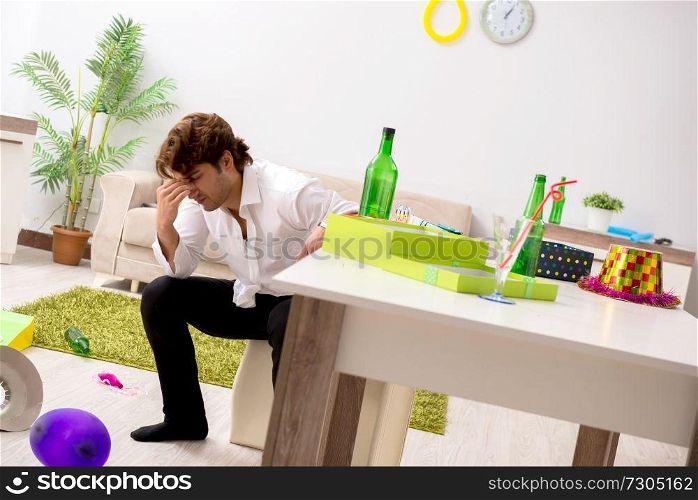Young man having hangover after party 