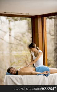 Young man having relax massage in the spa