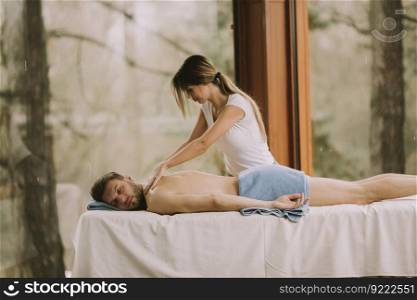 Young man having relax massage in the spa
