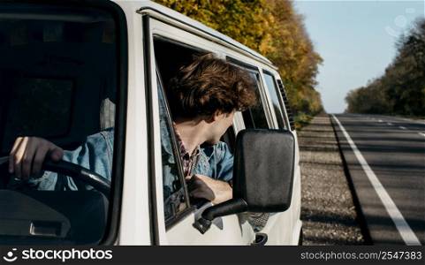 young man having roadtrip his van