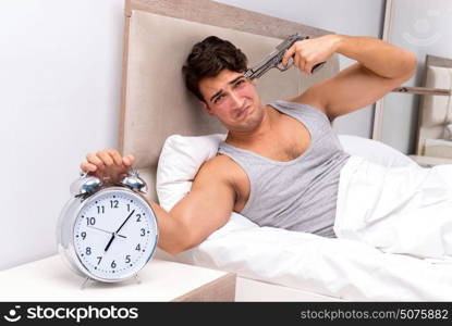 Young man having trouble waking up in the morning