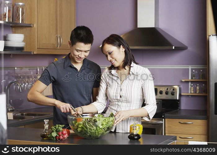 Young man helping a young woman prepare food