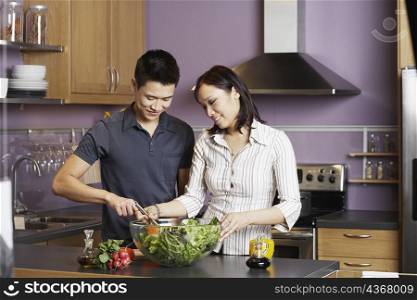 Young man helping a young woman prepare food