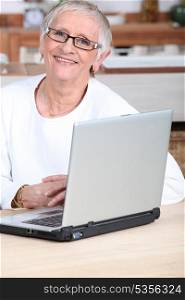 Young man helping senior woman buy online