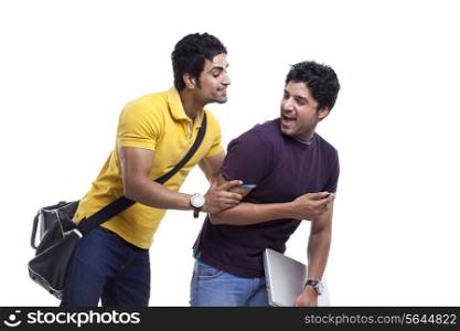 Young man hiding his cell phone from his curious friend