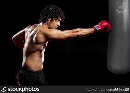 Young man hitting punching bag