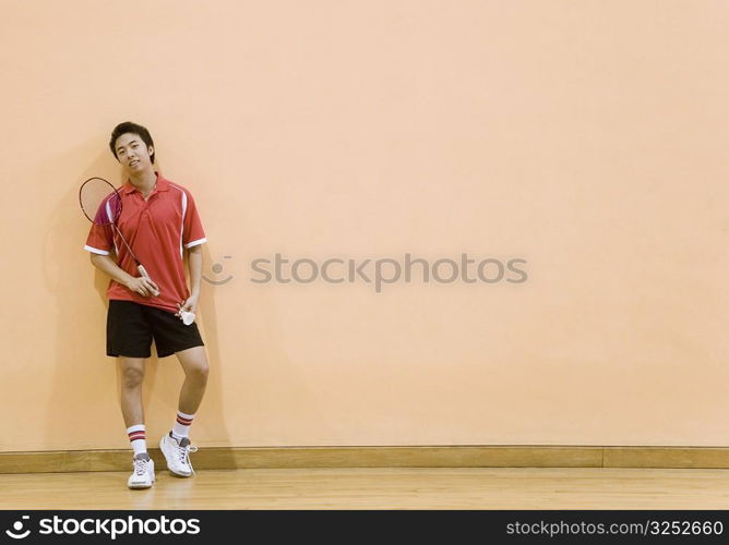 Young man holding a badminton racket and a shuttlecock