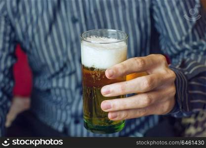 Young man holding a beer