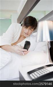 Young man holding a cordless phone